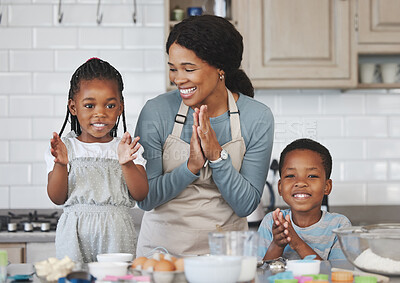 Buy stock photo Shot of a mother baking with her children at home