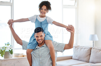 Buy stock photo Portrait of a father carrying his little daughter on his shoulders at home
