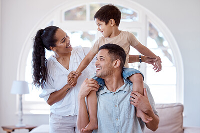 Buy stock photo Shot of a little boy bonding with his parents at home