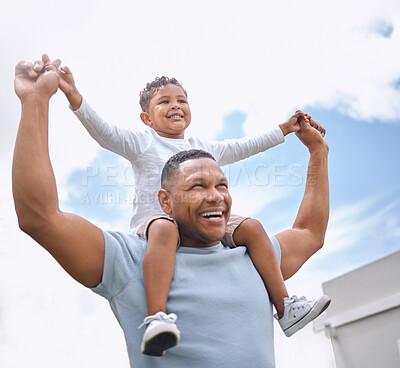 Buy stock photo Shot of a father and son having fun in their backyard at home