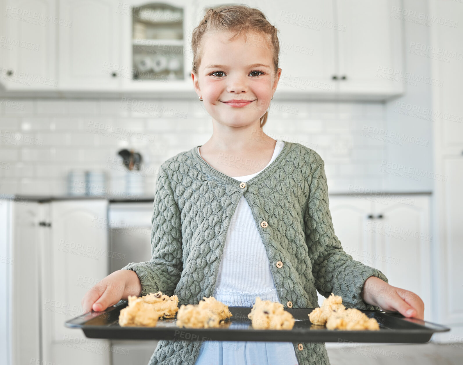 Buy stock photo Girl, portrait and learning baking in house for childhood development, growth and culinary education. Female kid, face and happy in apartment for cooking, hobby and fun with pride, snack and cookies