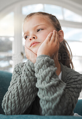 Buy stock photo Shot of a young girl looking bored at home