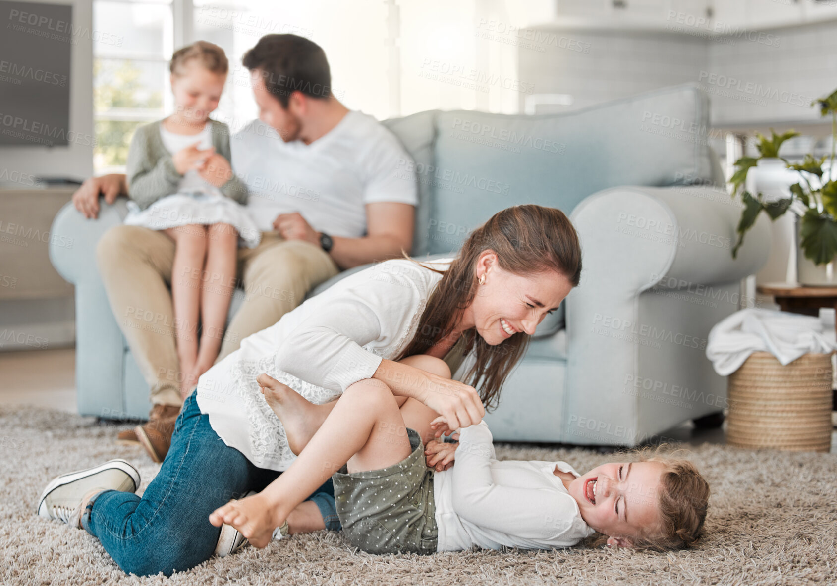 Buy stock photo Family, woman and playing with child on floor in living room for funny game, joke and support on weekend. Happy, mother and father bonding with kids at home for humor, love and laughing together