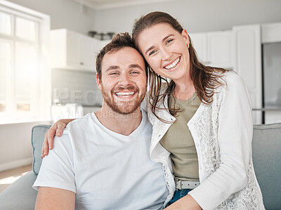 Buy stock photo Portrait of a young couple relaxing on a sofa at home
