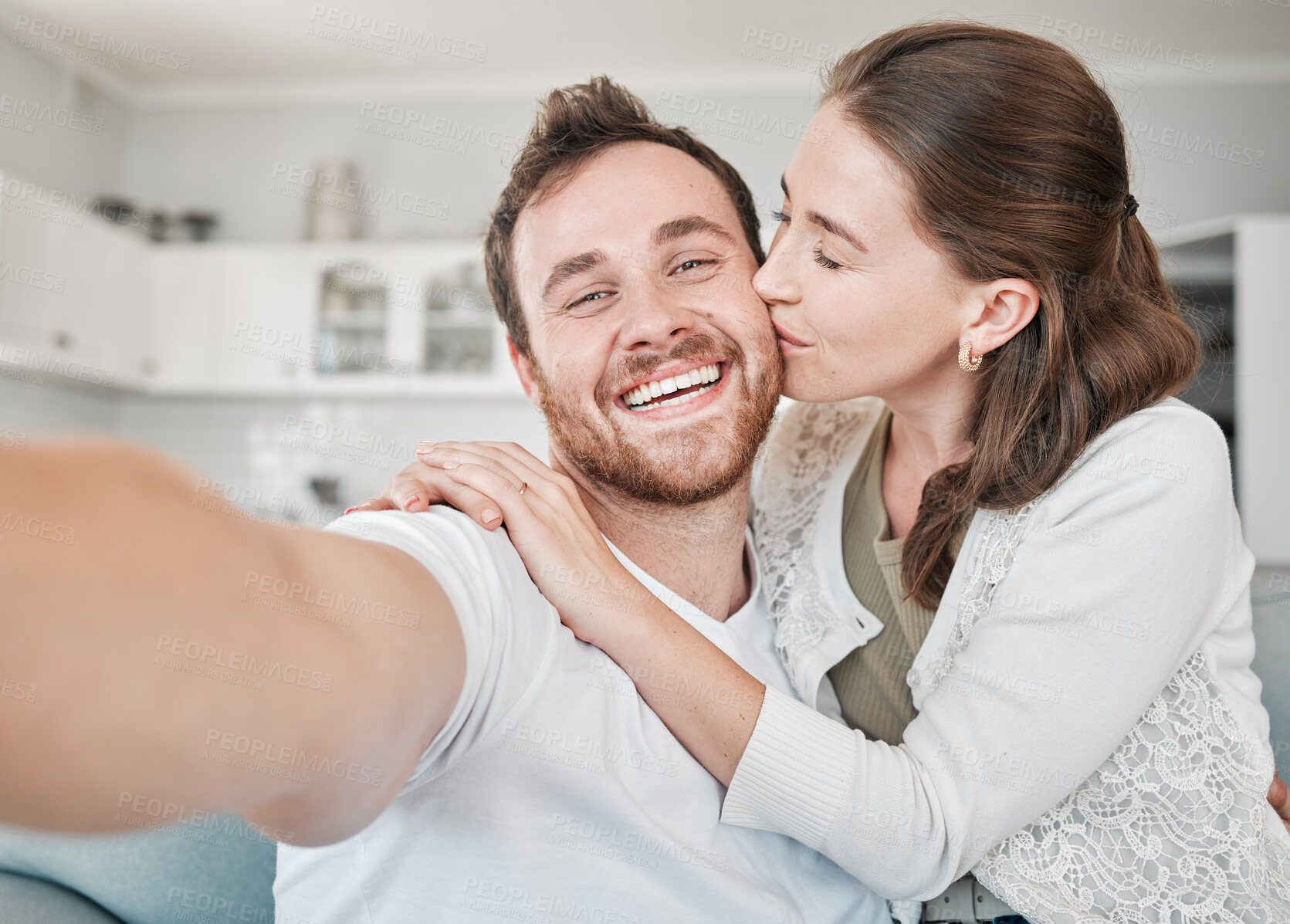 Buy stock photo Couple, kiss and portrait in home for selfie, photography and document memories for future in lounge. House, woman and man with affection for bonding, connection and profile picture for social media