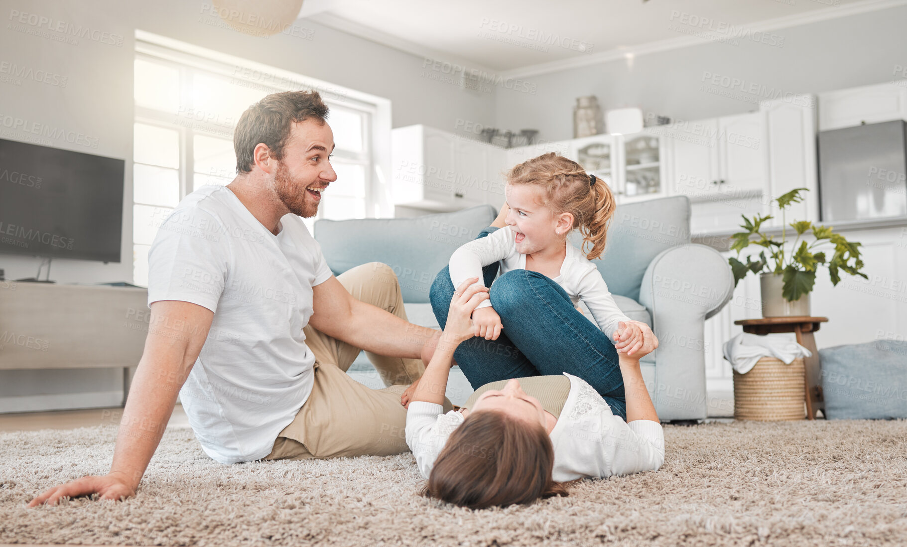 Buy stock photo Home, family and parents playing with child in living room for funny game, love and support on weekend. Excited, father and mother bonding with girl on carpet for joke, humor and laughing together