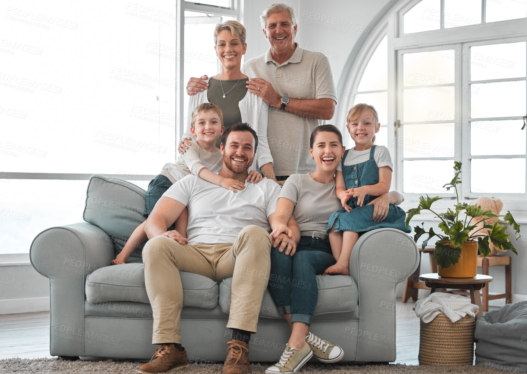 Buy stock photo Shot of a happy family relaxing on the sofa at home