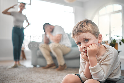 Buy stock photo Shot of a little boy looking sad while his parent argue at home