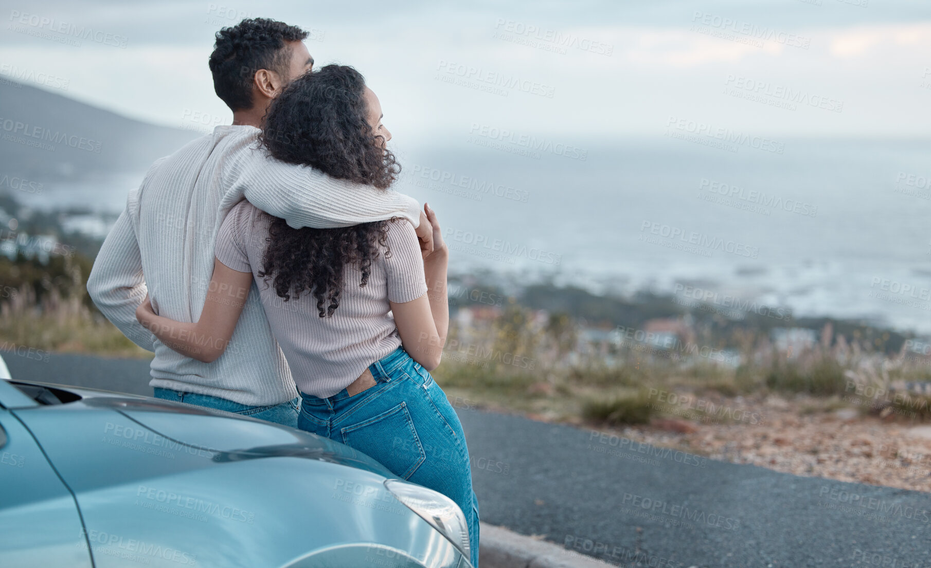 Buy stock photo Couple, ocean view and hug on road trip, holiday and hug for memory with love, back and bonding on hill. Man, woman and embrace with connection, thinking and outdoor for vacation on travel with car