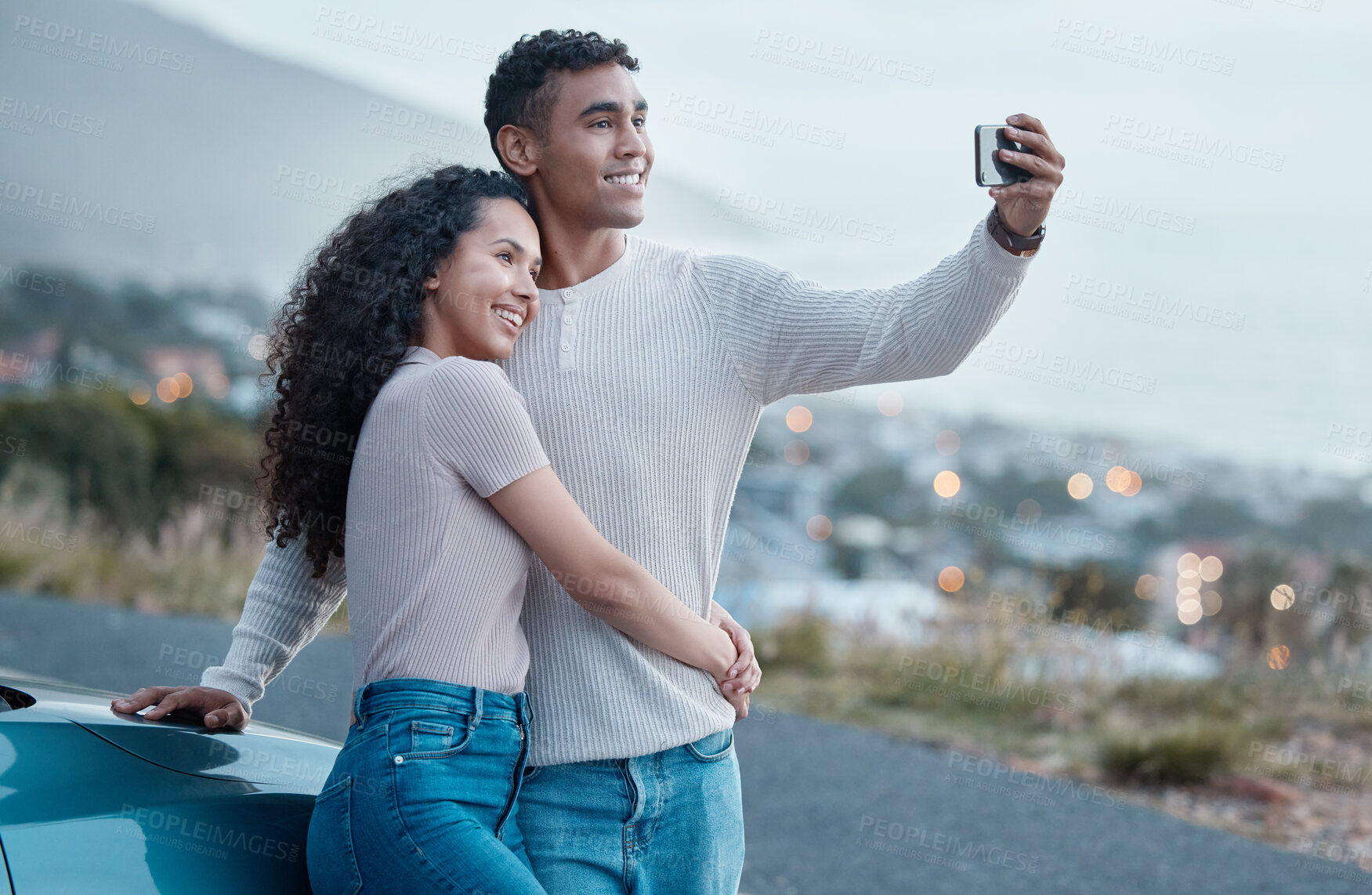 Buy stock photo Couple, selfie and car on road trip, vacation and hug for profile picture on mobile app with smile by ocean. Man, woman and happy for memory, photography or live streaming for journey on social media