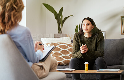 Buy stock photo Shot of a young woman having a therapeutic session with a psychologist