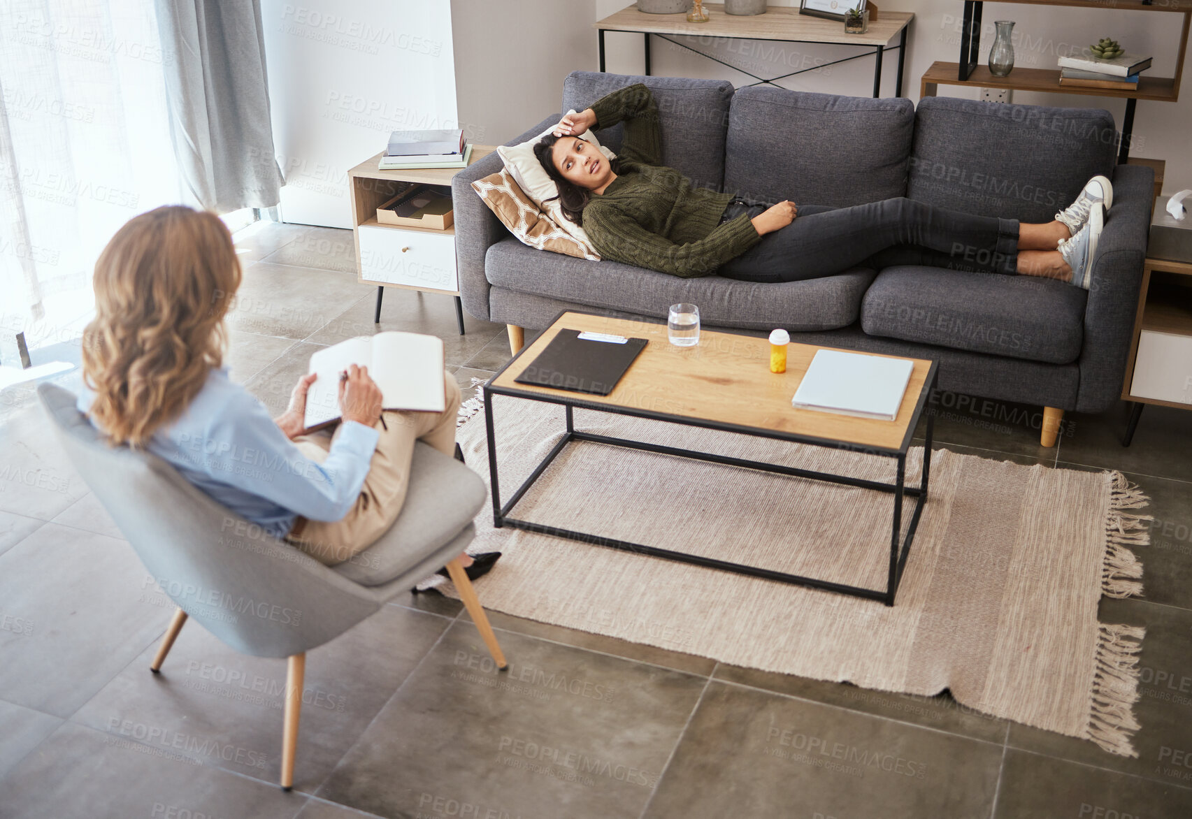 Buy stock photo Psychologist, woman and patient relax on couch for medical support, anxiety risk and discussion of trauma. Counseling, doctor and consultation on sofa for mental health, depression and ptsd.