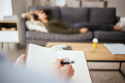 Buy stock photo Cropped shot of a psychologist writing notes during a therapeutic session with her patient