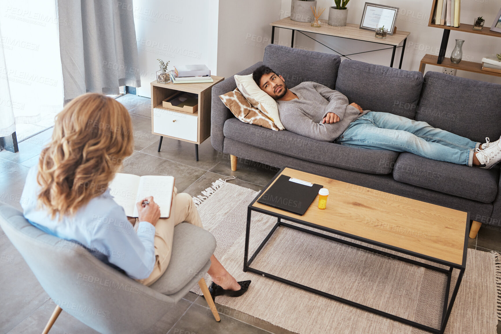 Buy stock photo Psychologist, man and patient relax on sofa for medical support, anxiety risk or discussion of trauma. Counseling, doctor and consultation on couch for mental health, depression or ptsd help