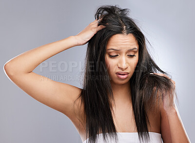 Buy stock photo Hair, damage loss and woman in studio with worry for split ends, haircare crisis and weak strand. Beauty, hairdresser and face of female person with frizz, texture and dry problem on gray background