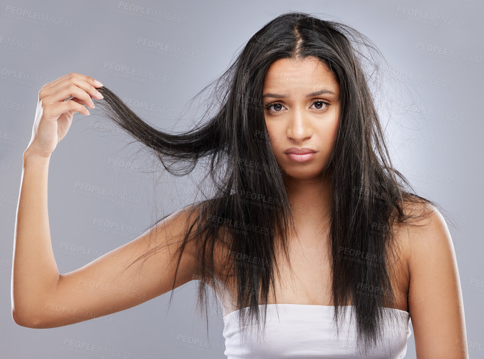 Buy stock photo Hair, damage and portrait of woman in studio with worry for split ends, haircare crisis and weak strand. Beauty, hairdresser and face of upset female person with frizz problem on gray background