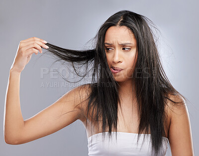 Buy stock photo Hair care, damage and woman with worry in studio for split ends, haircare crisis and weak strand. Beauty mockup, hairdresser and face of upset female person with frizz problem on gray background