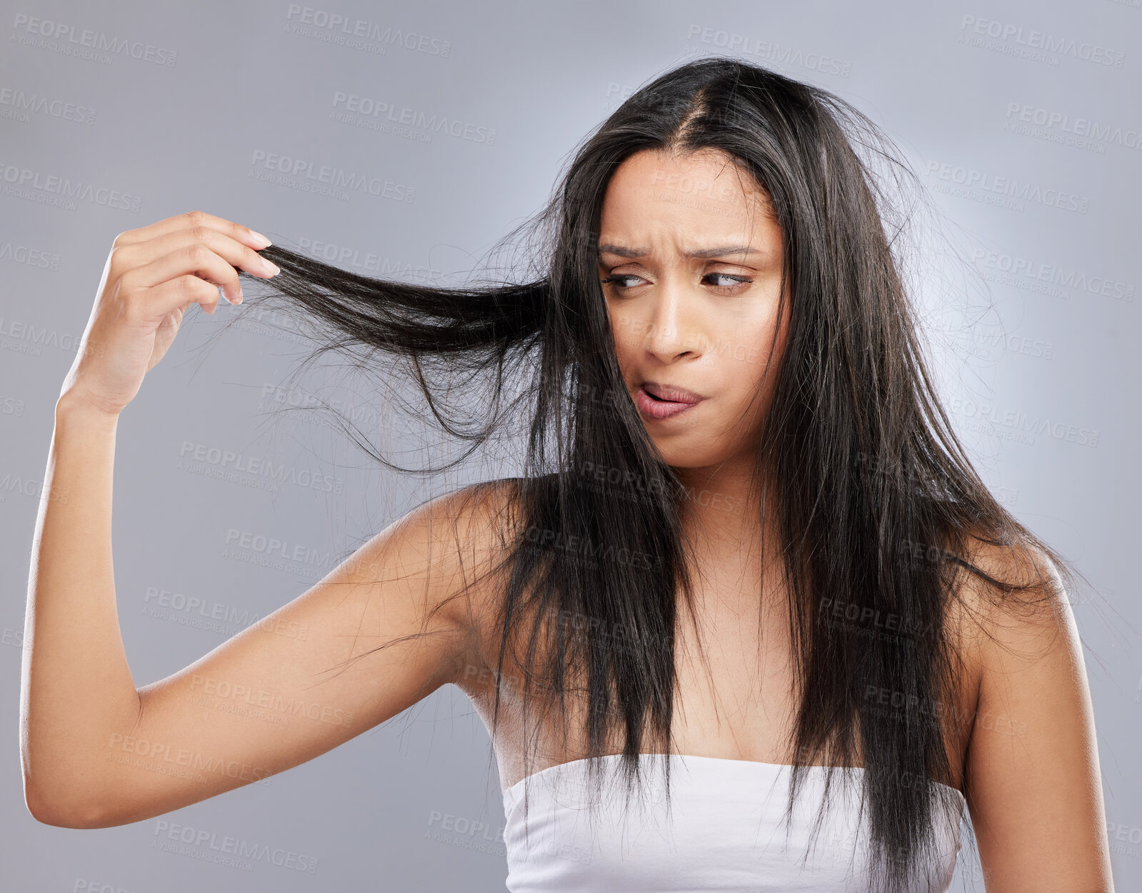 Buy stock photo Hair care, damage and woman with worry in studio for split ends, haircare crisis and weak strand. Beauty mockup, hairdresser and face of upset female person with frizz problem on gray background