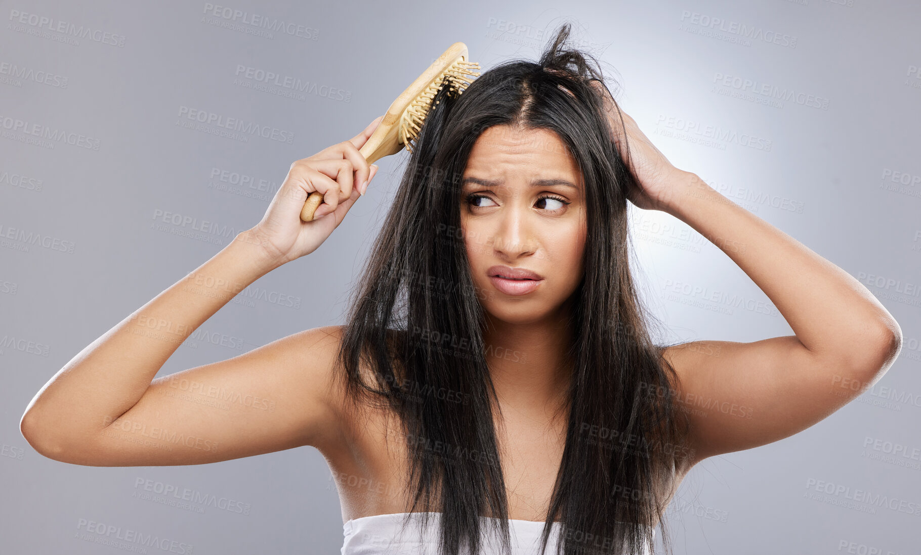 Buy stock photo Hair, damage and woman with brush in studio with worry for knots, haircare crisis and weak texture. Beauty, hairdresser and face of female person with frizz, tangle and dry problem on gray background