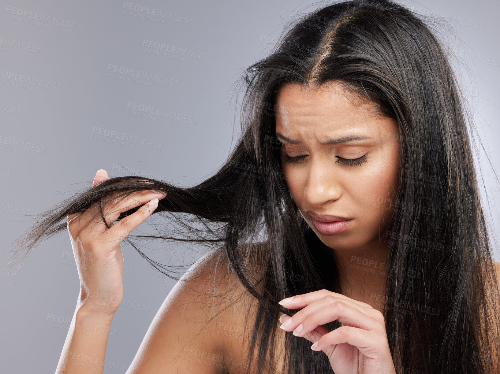 Buy stock photo Hair care, crisis and face of woman in studio with worry for split ends, haircare and weak strand. Beauty, hairdresser and upset female person with frizz, dry and loss problem on gray background