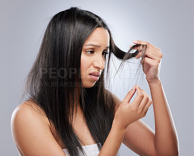 Buy stock photo Hair problem, damage and woman in studio with worry for split ends, haircare crisis and weak tips. Beauty, salon and face of upset female person with frizz, dry texture and loss on gray background