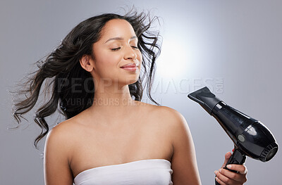 Buy stock photo Woman, studio and blow dry hair for care in morning isolated on white background. Beauty, volume and eyes closed, getting ready and heat for grooming in salon with appliance for styling in Canada.