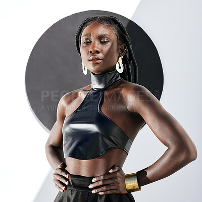 Buy stock photo Shot of an attractive young woman posing in a black outfit against a wall with a circle on it