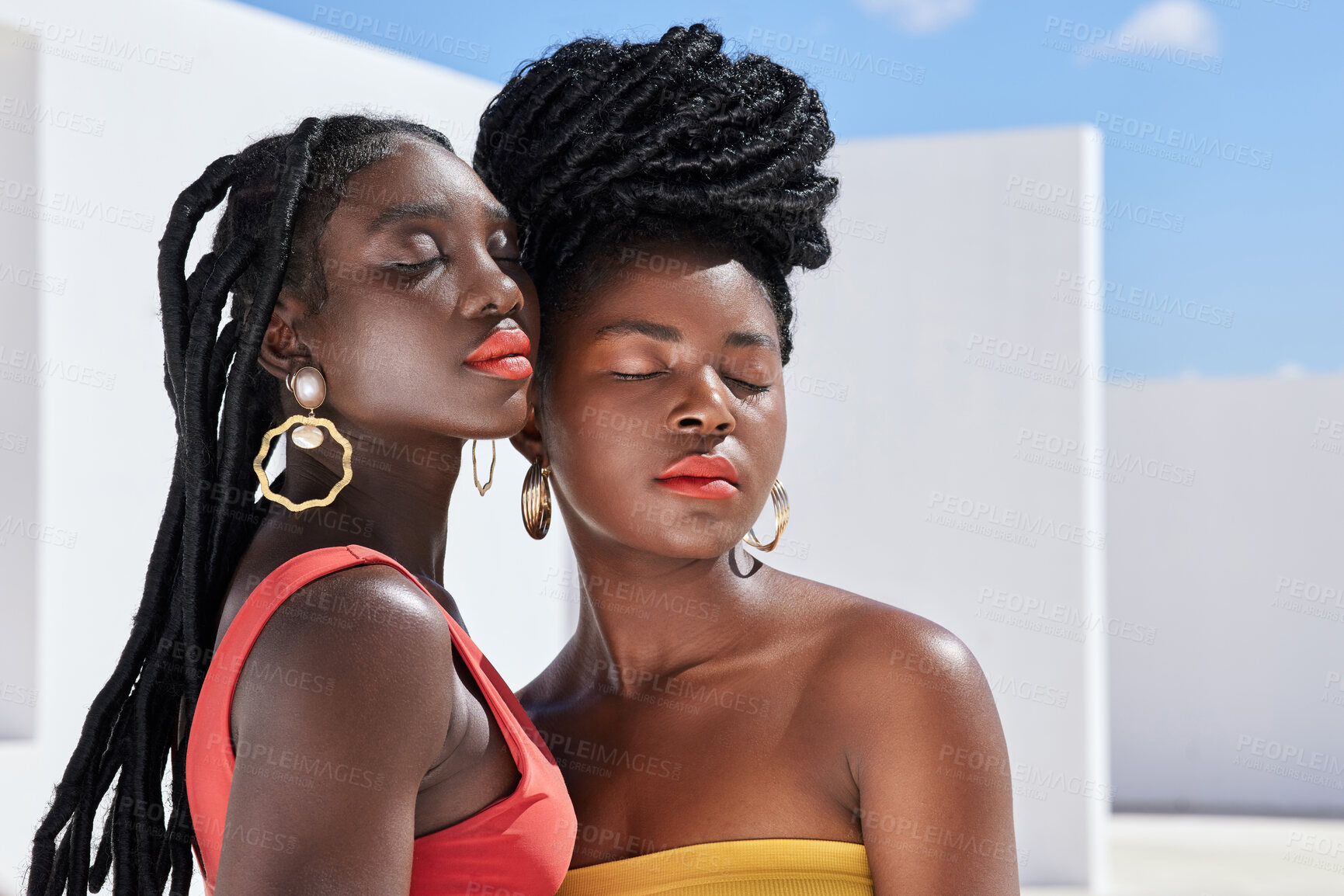 Buy stock photo Cropped shot of two attractive young women posing on a rooftop outdoors