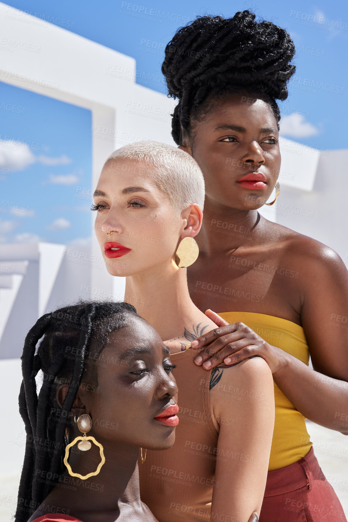 Buy stock photo Cropped shot of three attractive young women posing on a rooftop outdoors