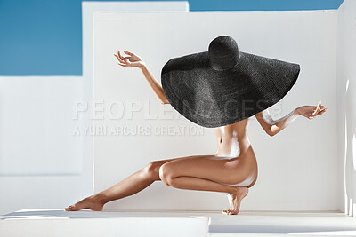 Buy stock photo Shot of an unrecognizable woman posing  nude in a summer hat outdoors