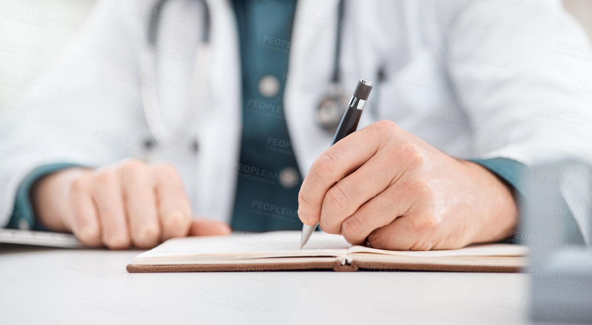 Buy stock photo Closeup shot of an unrecognisable doctor writing notes in a medical office