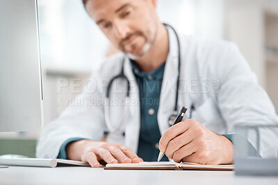 Buy stock photo Closeup shot of a mature doctor writing notes in a medical office