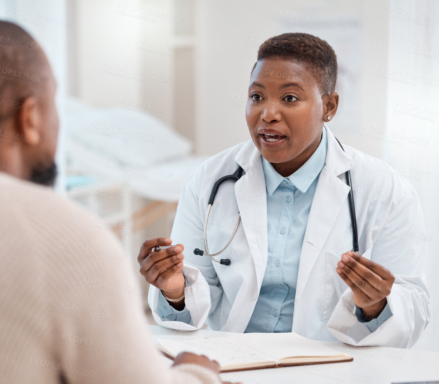 Buy stock photo Shot of a young doctor having a consultation with a patient in a medical office