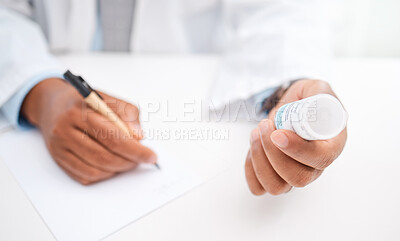 Buy stock photo Closeup shot of an unrecognisable doctor writing notes while holding a bottle of tablets in a medical office
