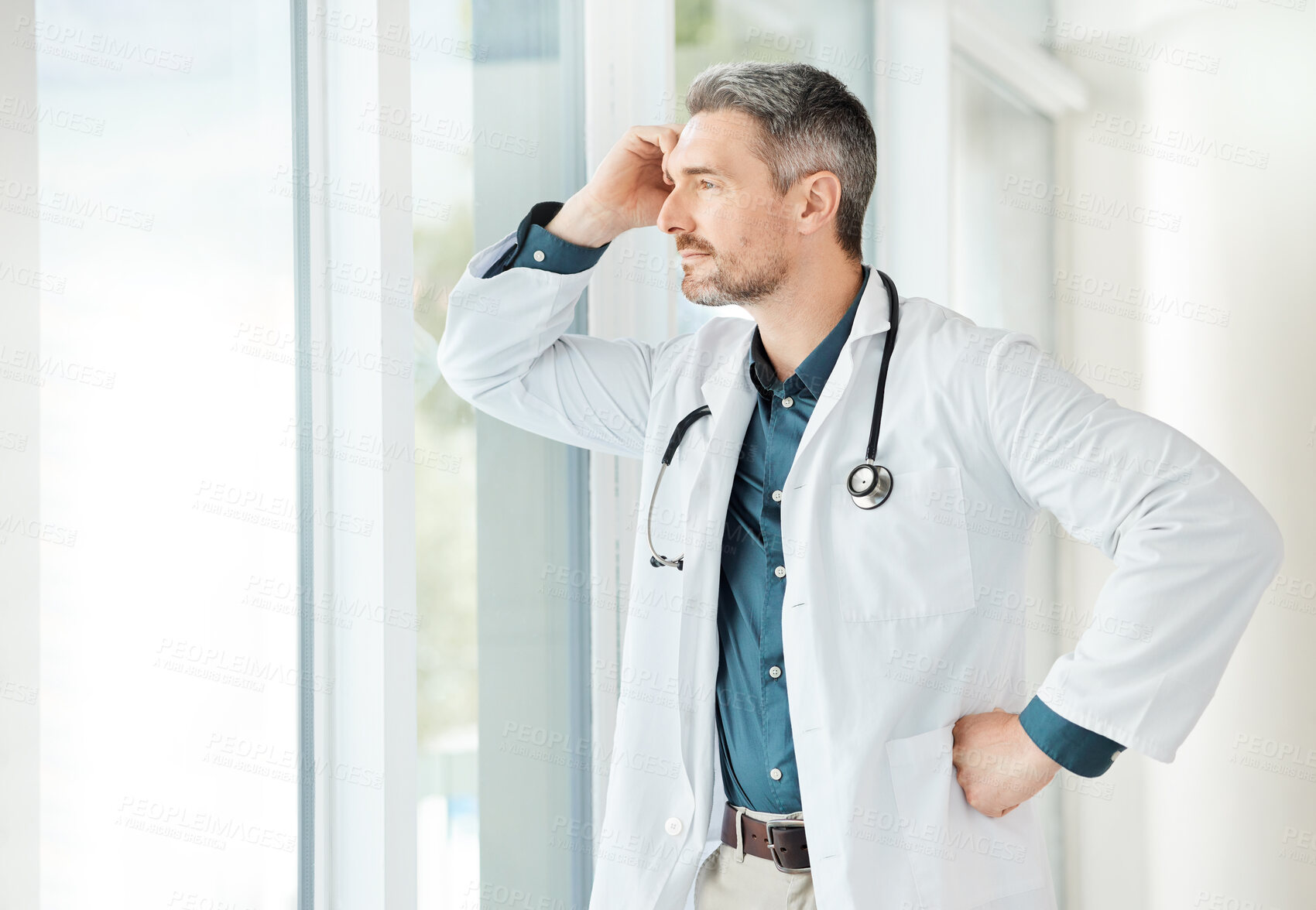 Buy stock photo Shot of a male doctor having a stressful day at work