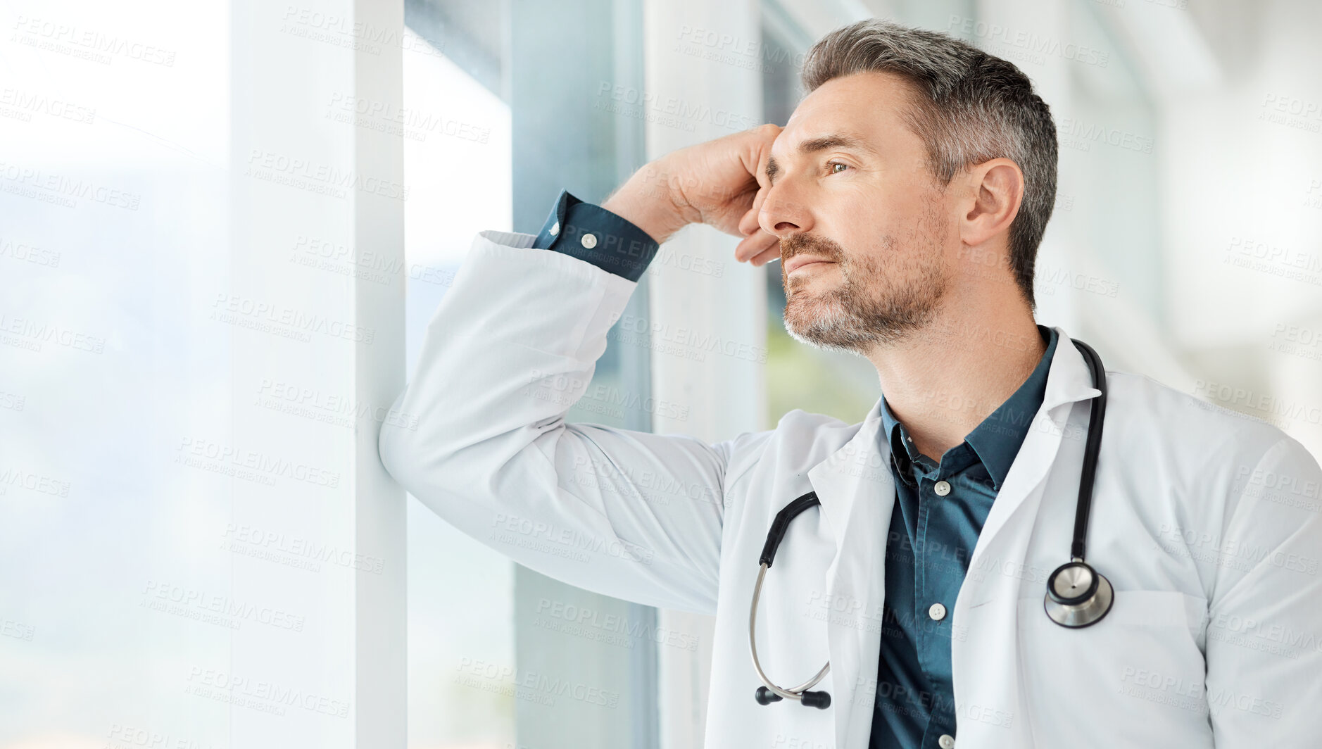 Buy stock photo Shot of a male doctor having a stressful day at work