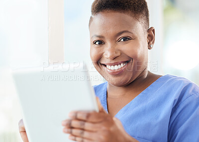 Buy stock photo Shot of a young nurse using a tablet in a office