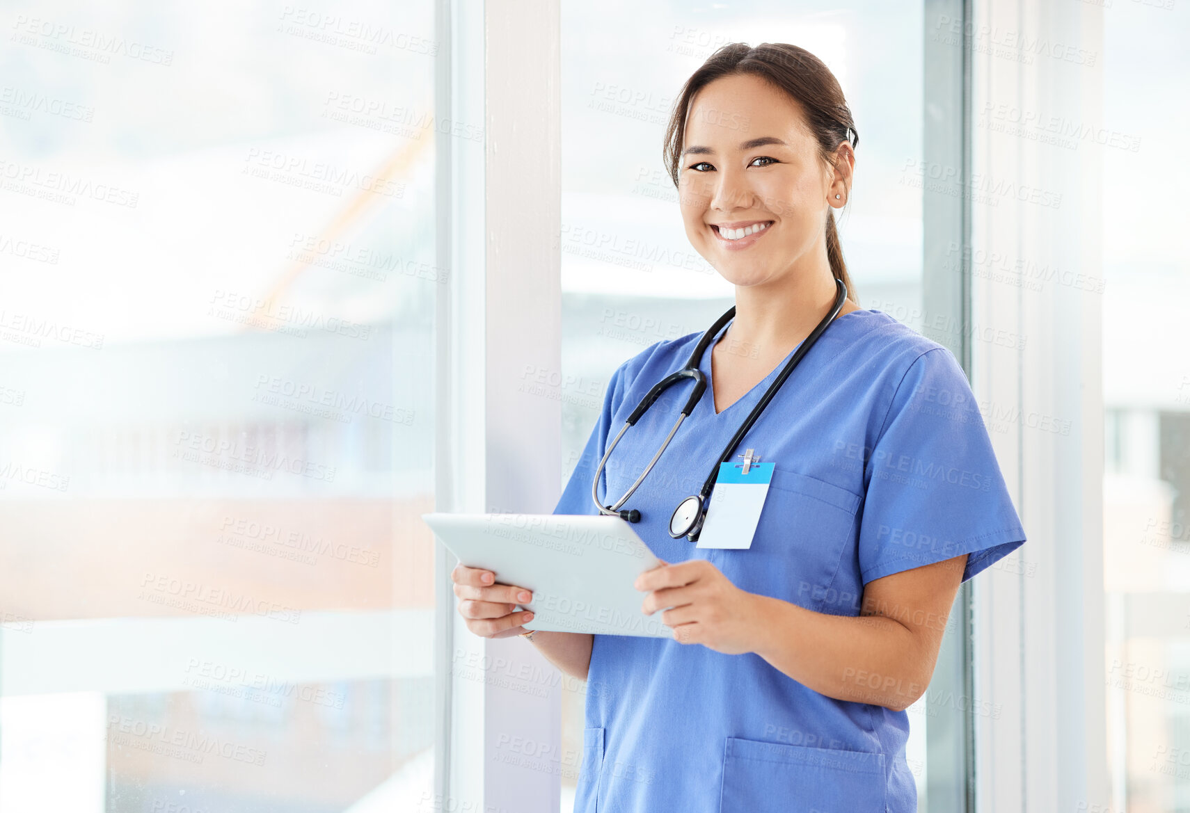 Buy stock photo Shot of a young nurse using a tablet in a office