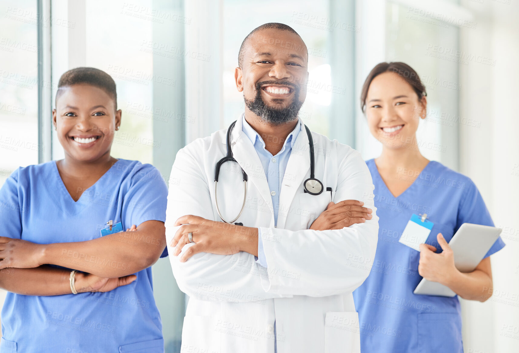 Buy stock photo Shot of a group of medical practitioners standing together in a hospital