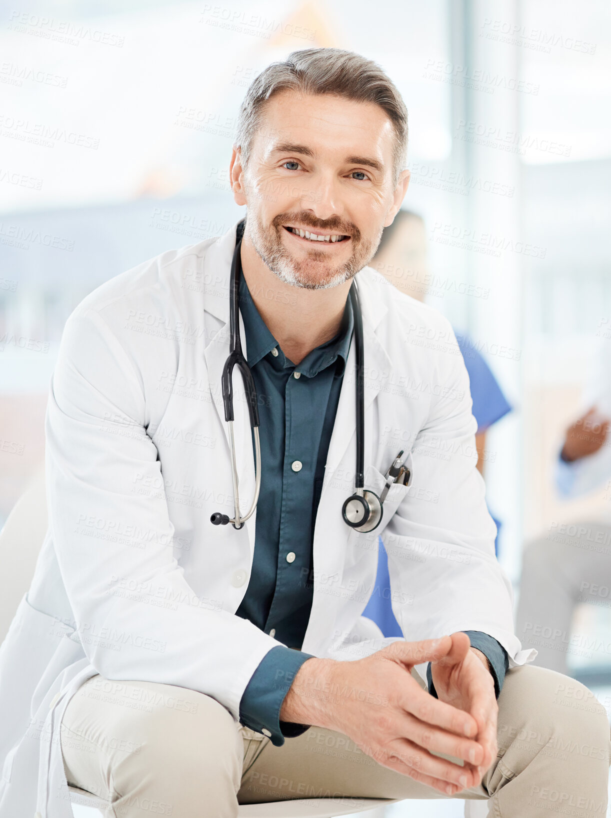 Buy stock photo Shot of a senior doctor sitting alone in his clinic