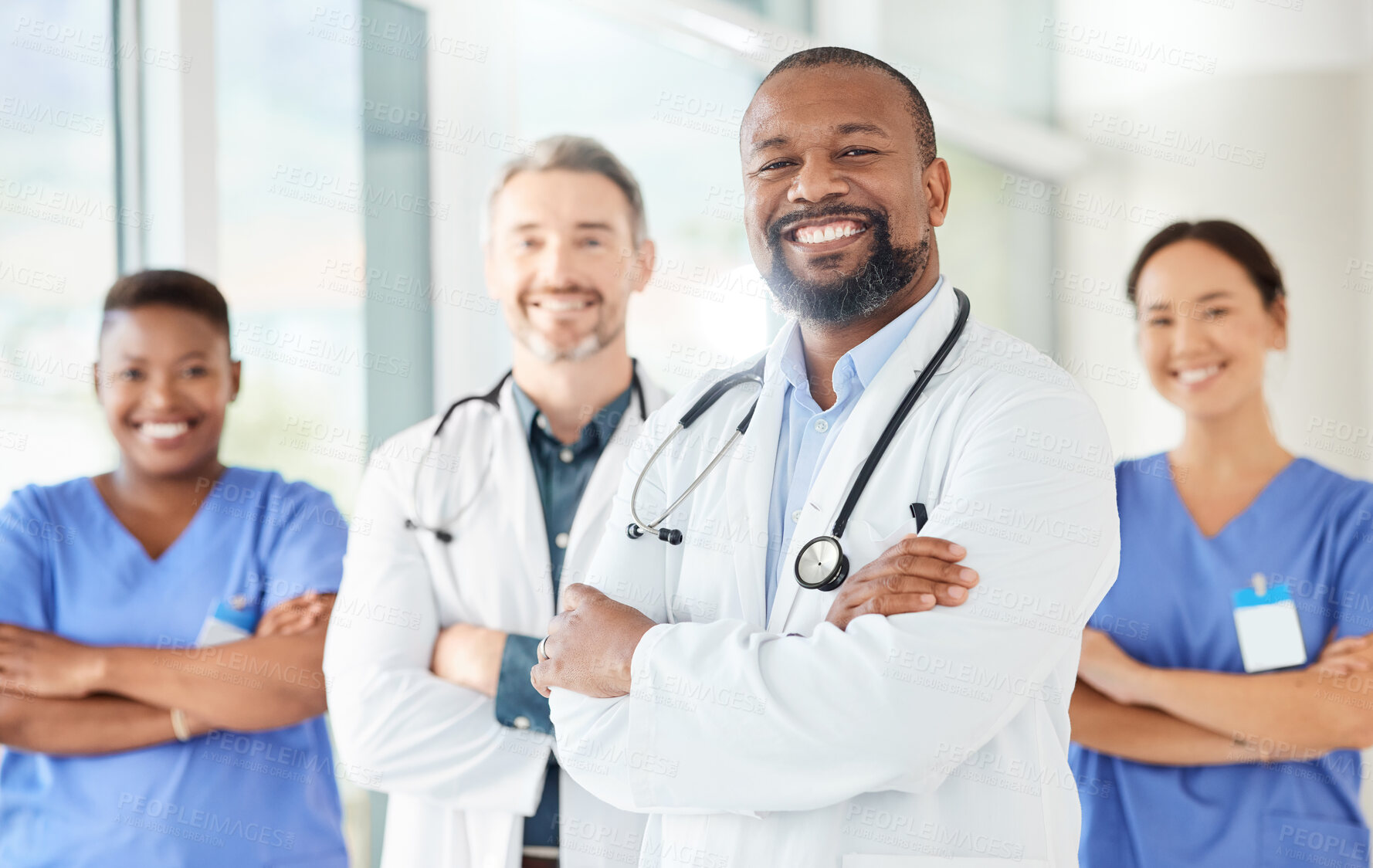 Buy stock photo Shot of a group of medical practitioners standing together in a hospital