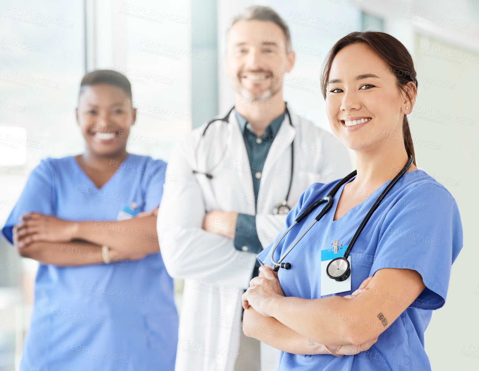 Buy stock photo Shot of a group of medical practitioners standing together in a hospital