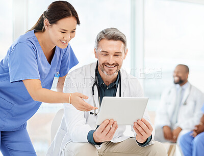 Buy stock photo Shot of two doctors using a tablet in a office