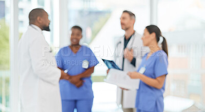 Buy stock photo Shot of a group of medical practitioners analysing x-rays in a hospital