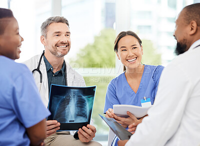 Buy stock photo Shot of a group of medical practitioners analysing x-rays in a hospital