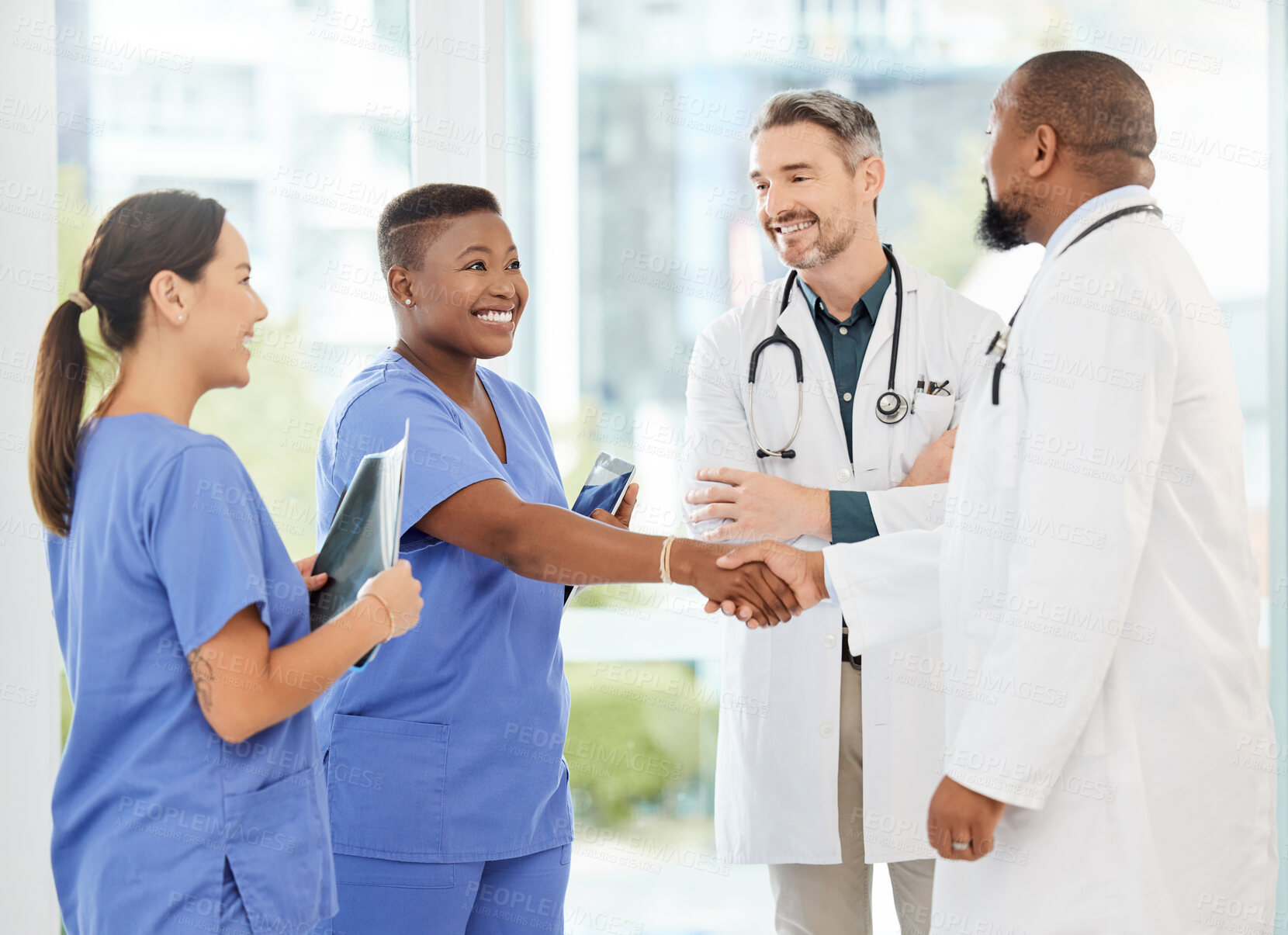 Buy stock photo Shot of a group of medical practitioners standing together in a hospital