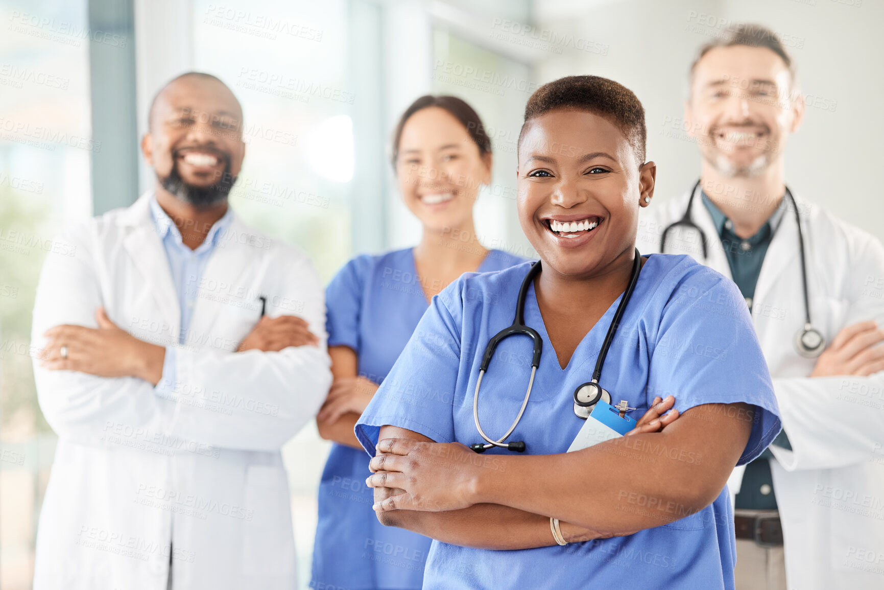 Buy stock photo Shot of a group of medical practitioners standing together in a hospital