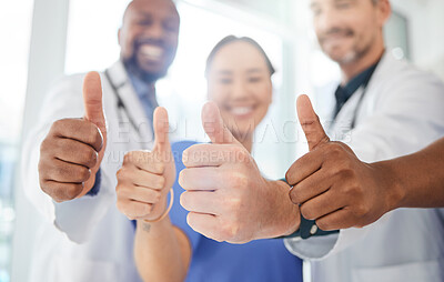 Buy stock photo Shot of a group of doctors showing a thumbs up in a office