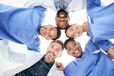 Buy stock photo Portrait of a group of medical practitioners joining their heads together in a huddle