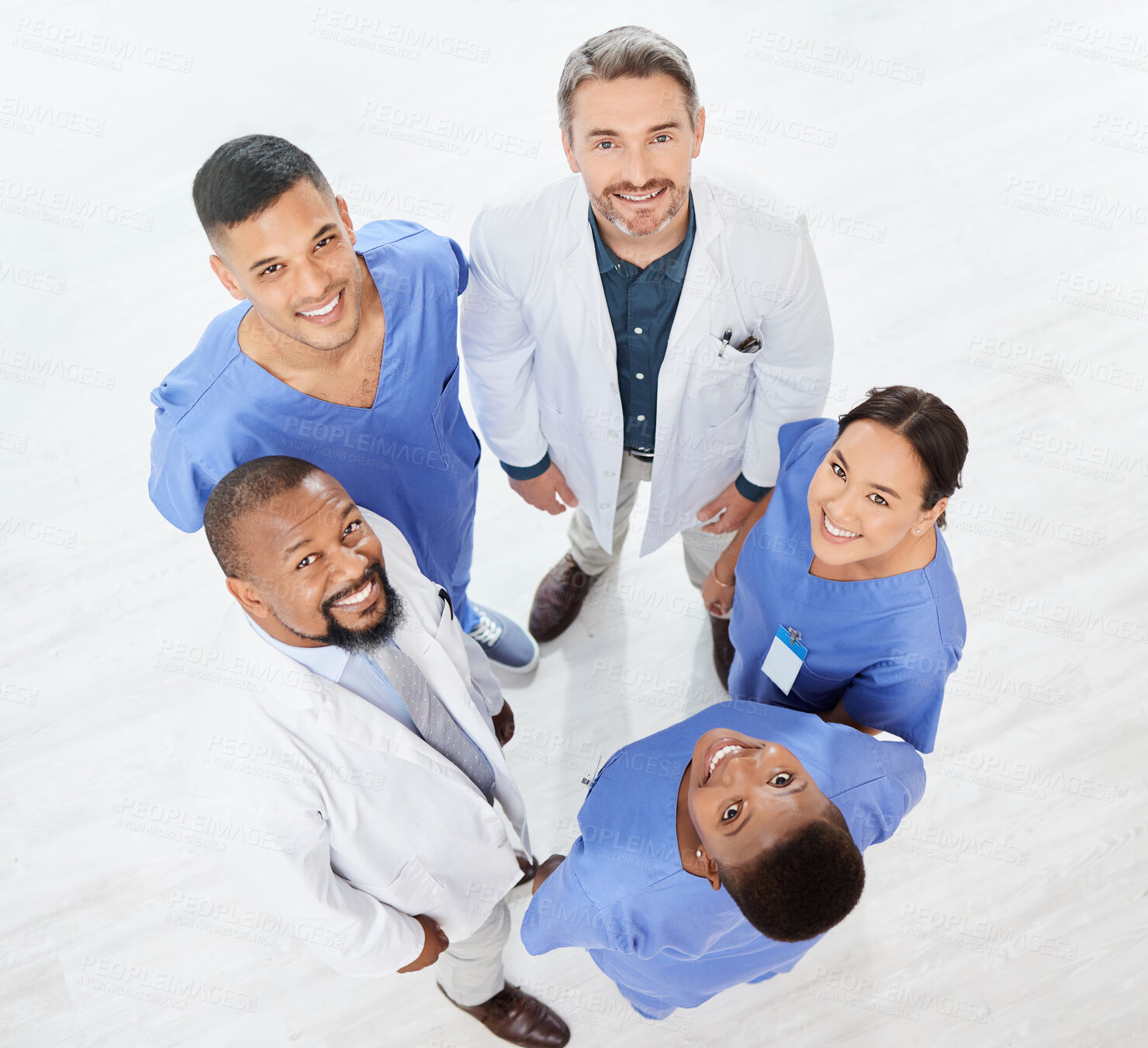 Buy stock photo Shot of a group of medical practitioners standing together in a hospital